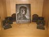 Group of bas-relief plaques and bookends depicting Theodore Roosevelt and his home.